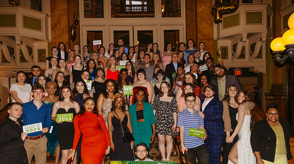 Students pose on a stairway